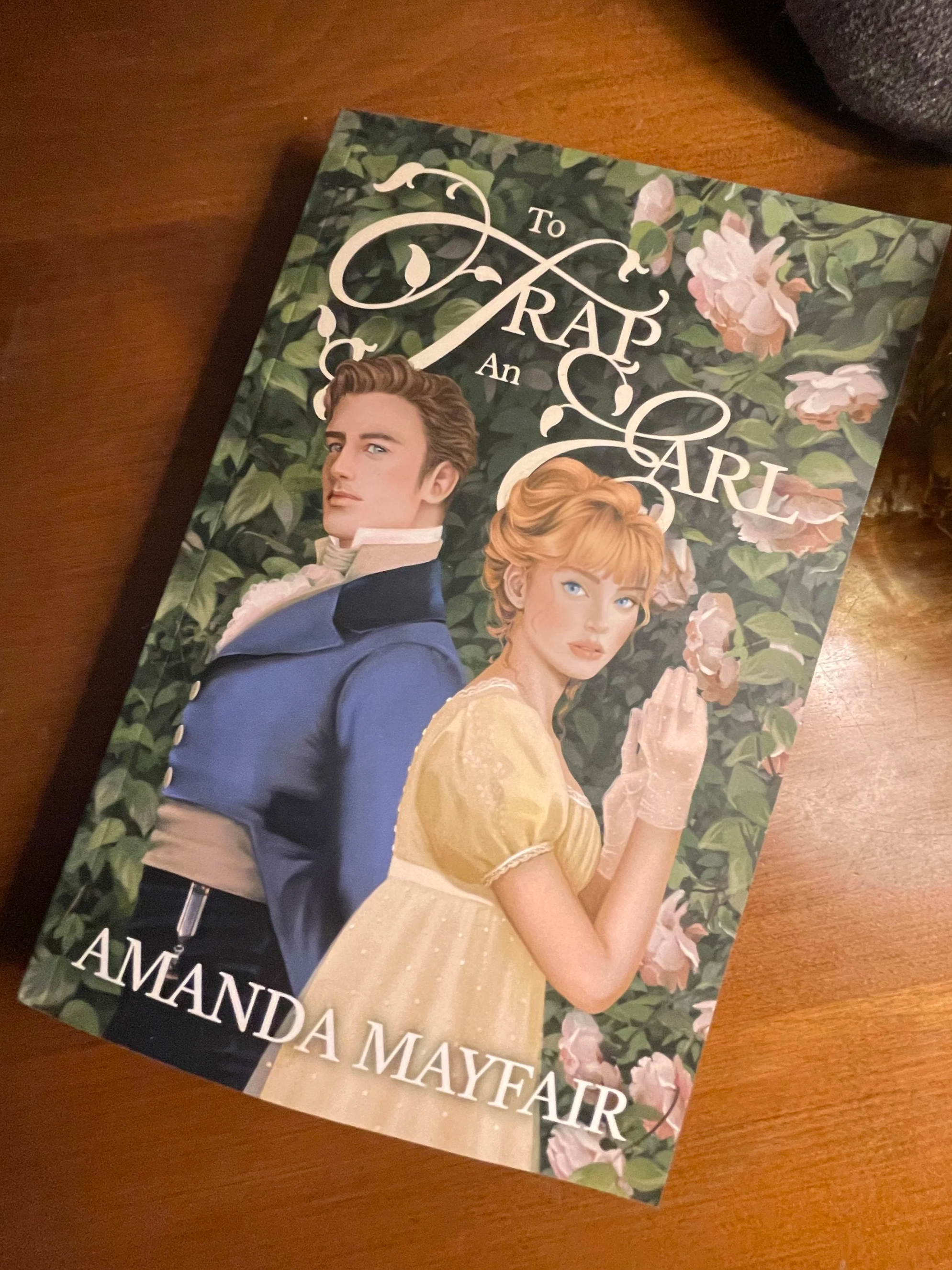 Book cover titled 'To Trap an Austen' featuring an illustrated man and woman in historical attire, surrounded by pink roses and green foliage.