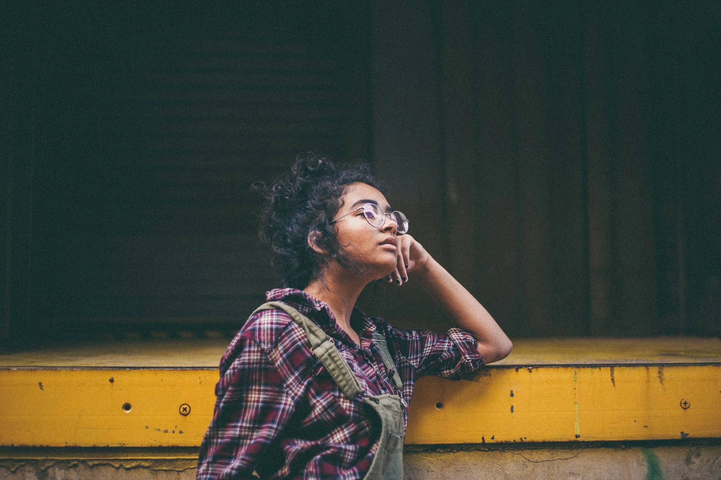 Adult sitting outdoors in a reflective moment