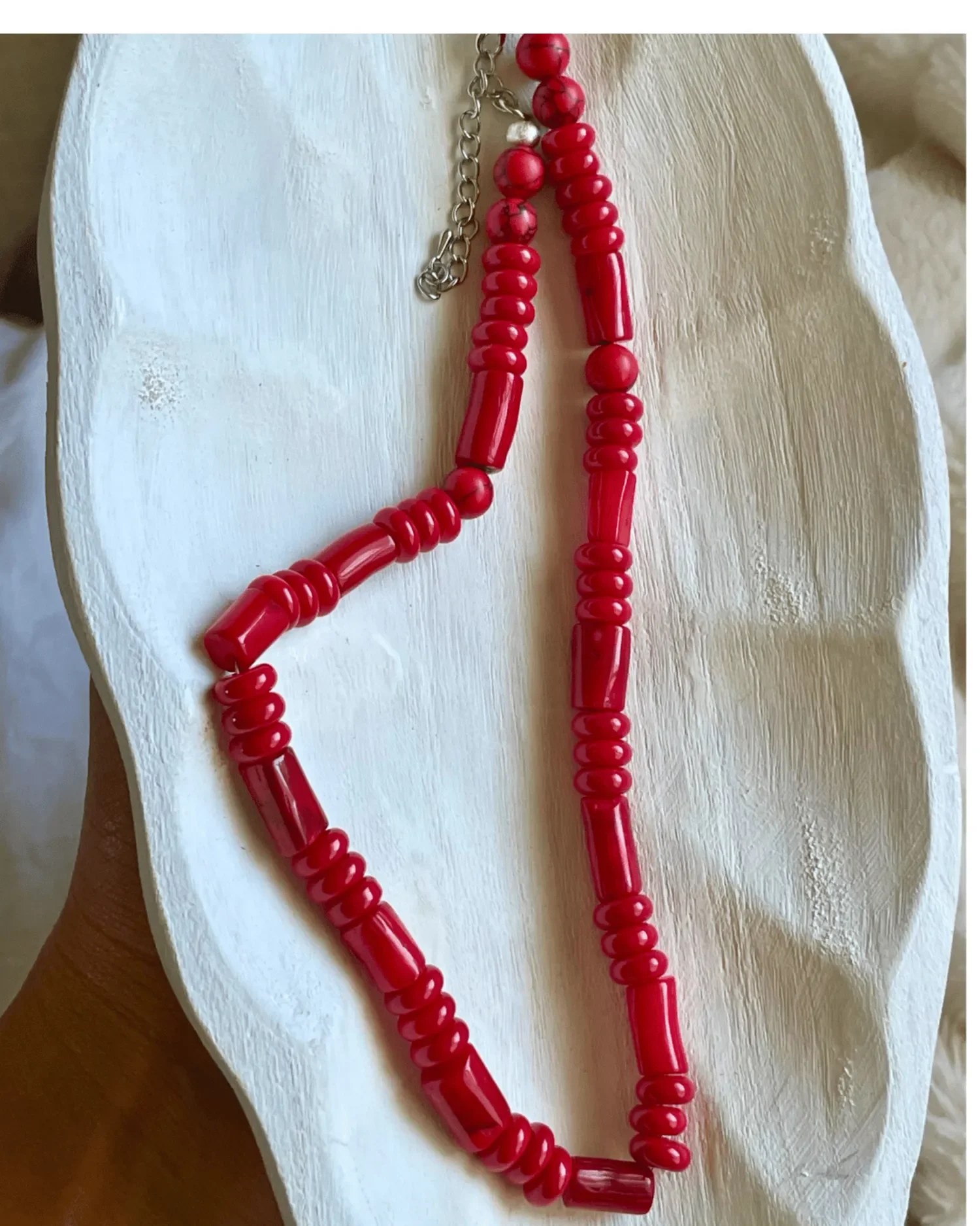 Handmade red gemstone necklace with mixed red beads and sterling silver clasp, called The Scarlett Necklace.