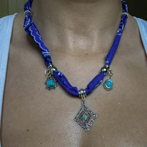 women wearing blue paisley bandana necklace with silver southwestern and turquoise charms accented with silver beads