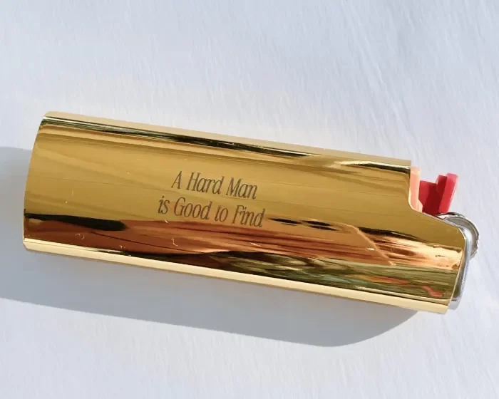 A Hard Man is Good to Find engraved gold lighter case cover
