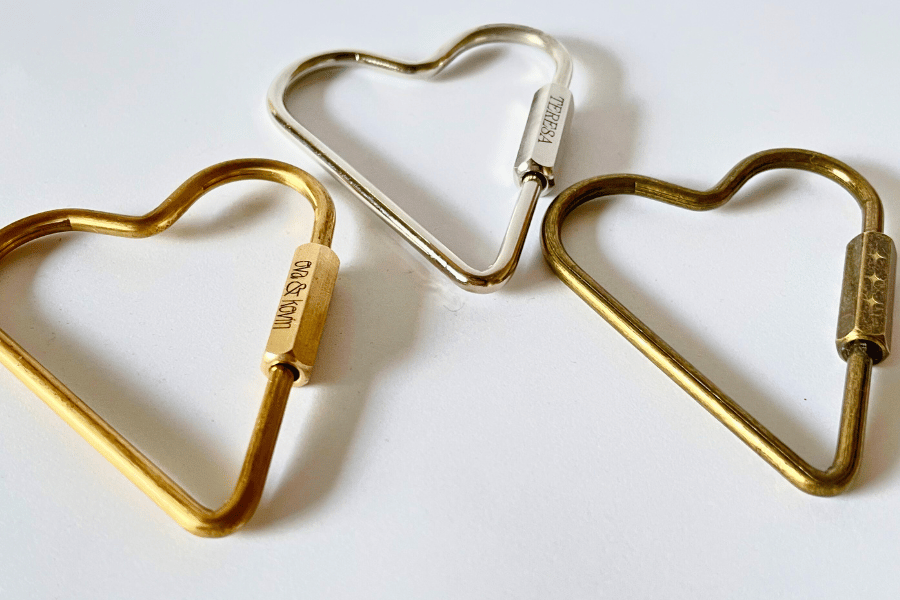 Set of three heart carabiner keychains in brass, chrome silver, and rustic brass with custom engravings