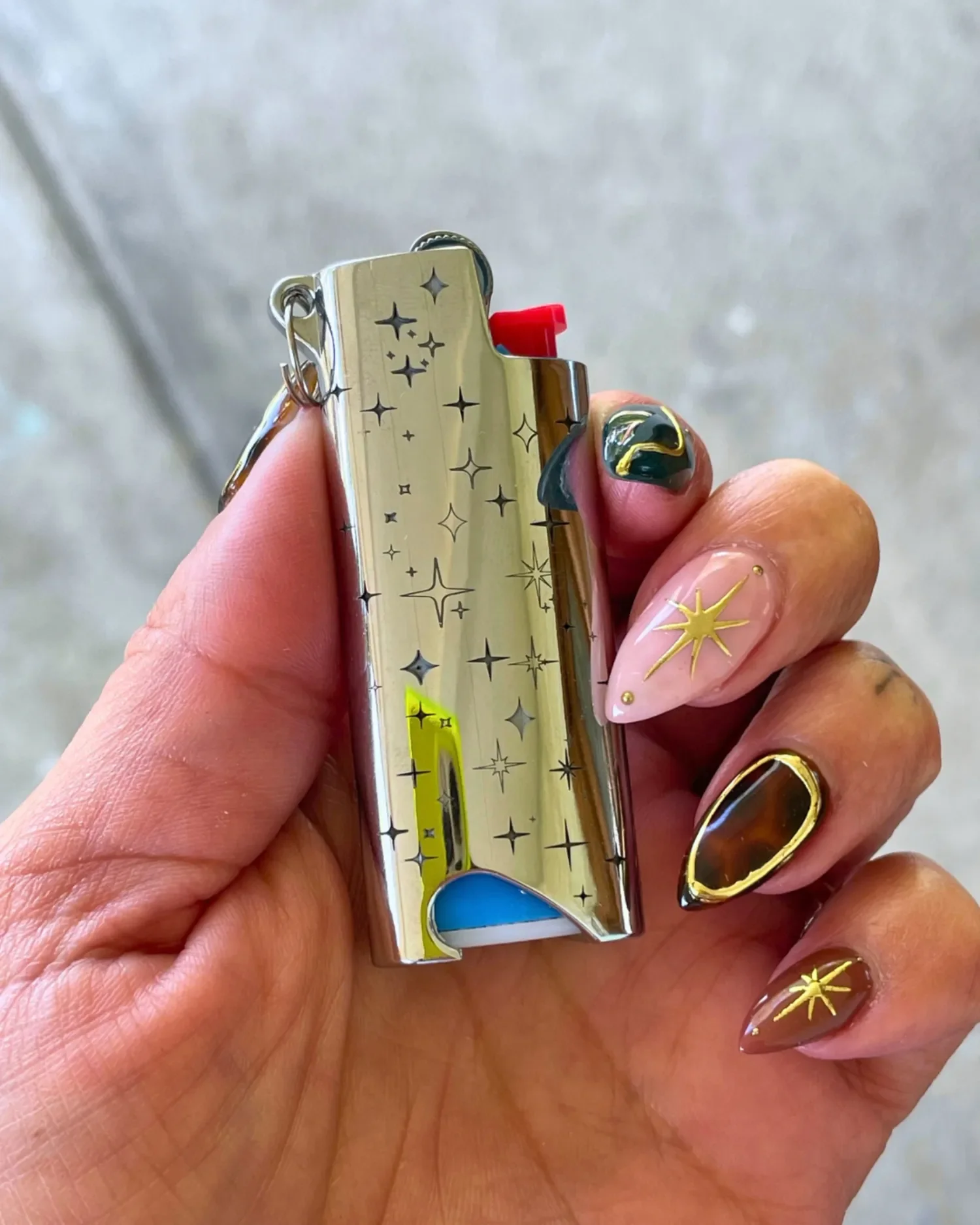 woman holding star design engraved bic j5 lighter case keychain