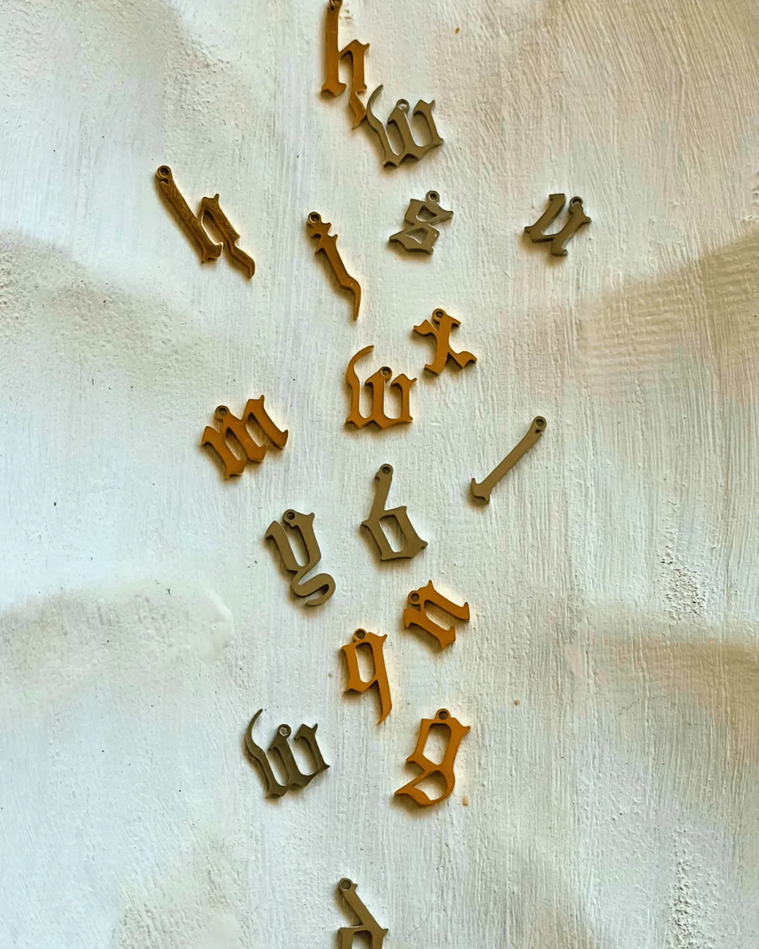 silver and gold blackletter charms