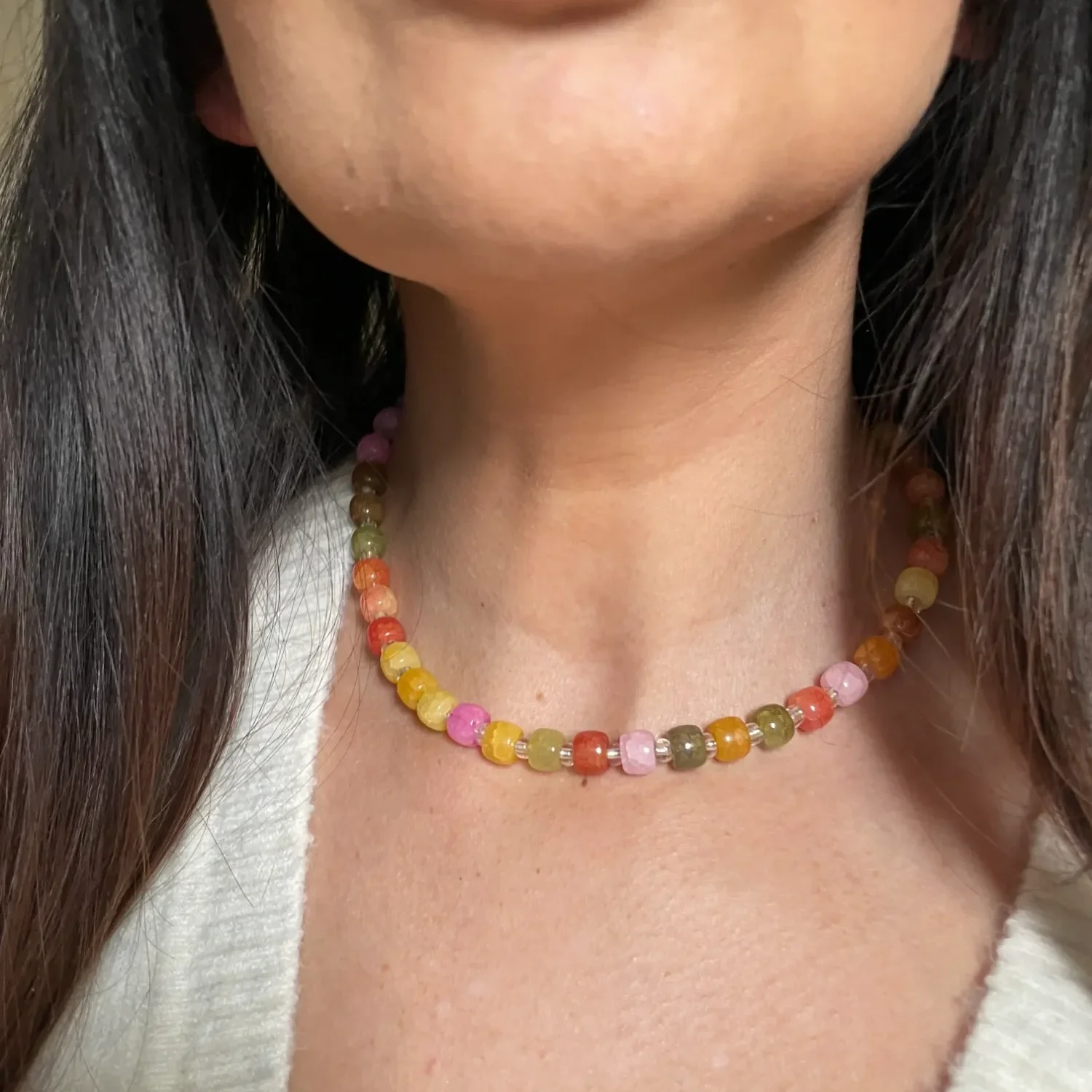 women wearing pink and neutral acrylic beaded choker necklace