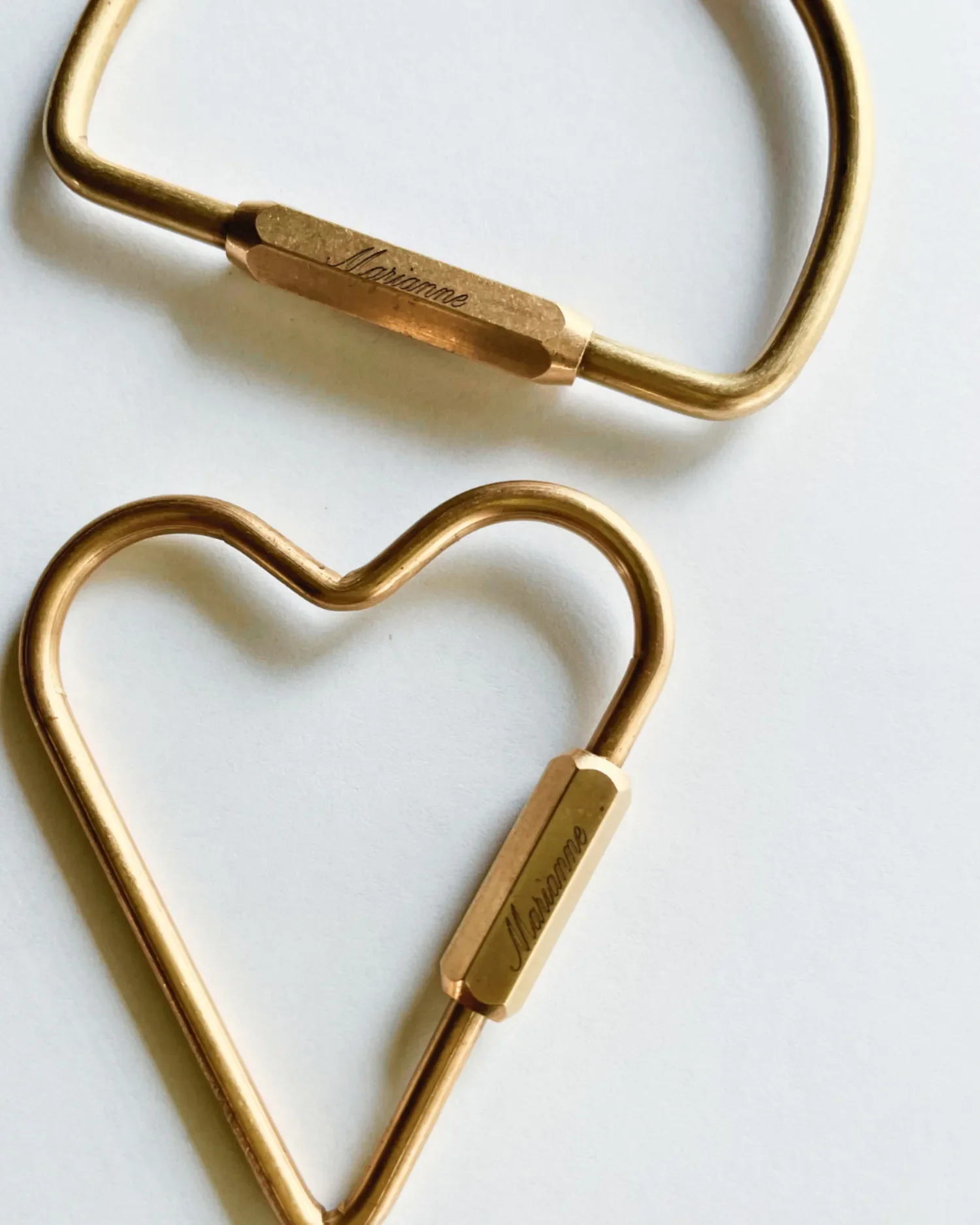 Close up of engraved brass locking carabiner key rings