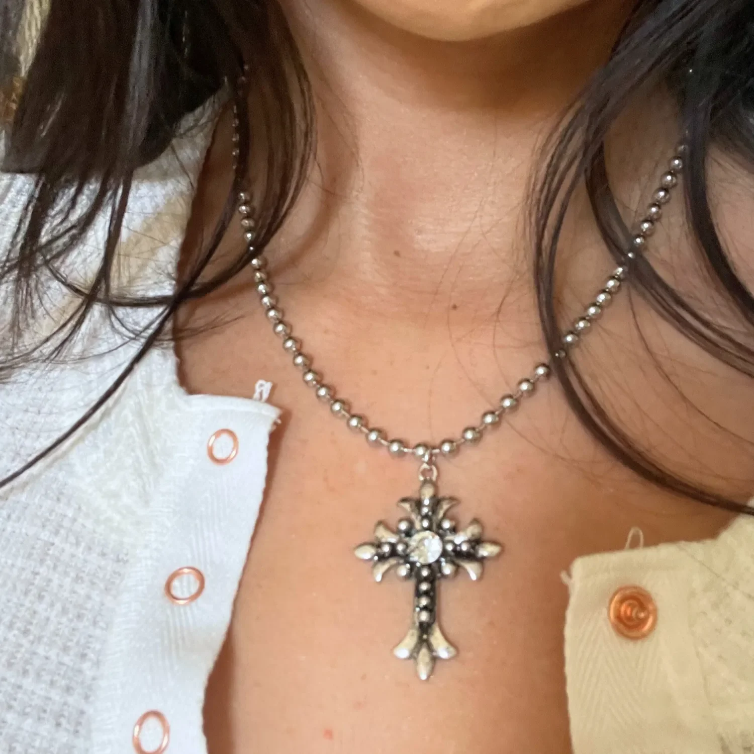 Vintage-inspired Gothic cross pendant necklace with Swarovski crystal accent on polished stainless steel ball chain, photographed in natural light.