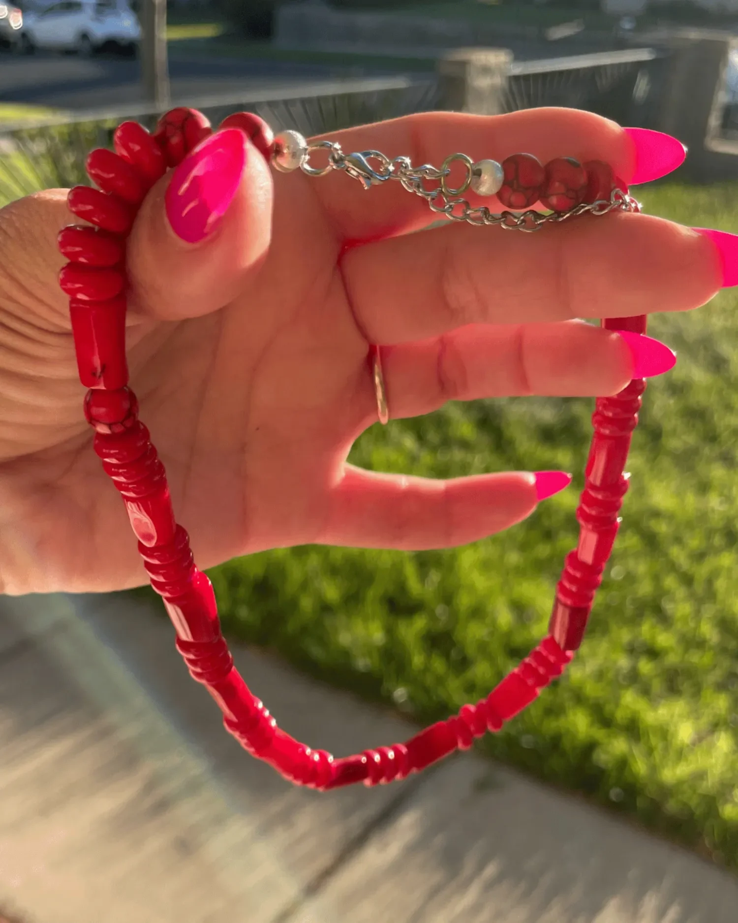 Handmade red gemstone necklace with mixed red beads and sterling silver clasp, called The Scarlett Necklace.