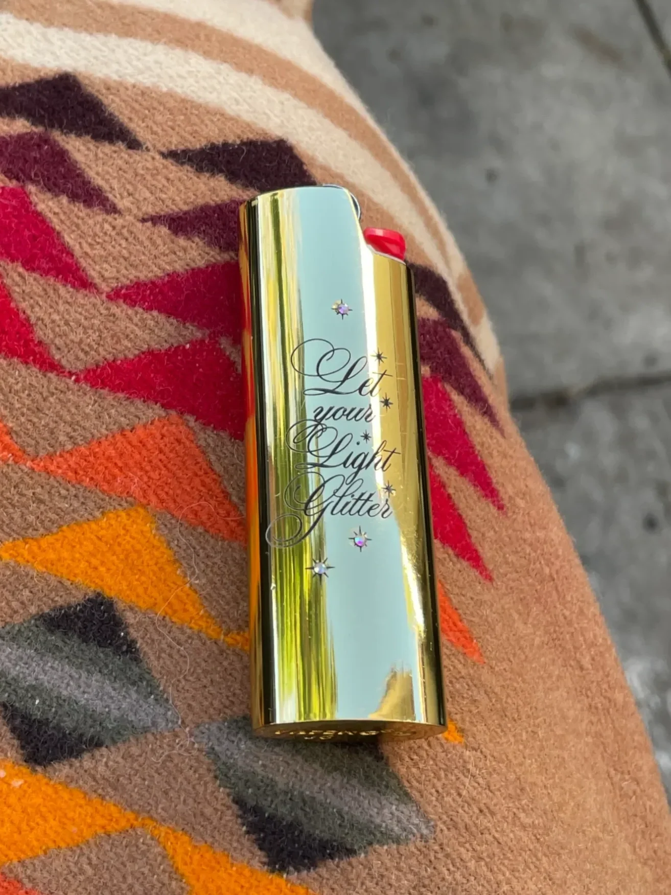 Gold engraved lighter case with custom name in cursive font.