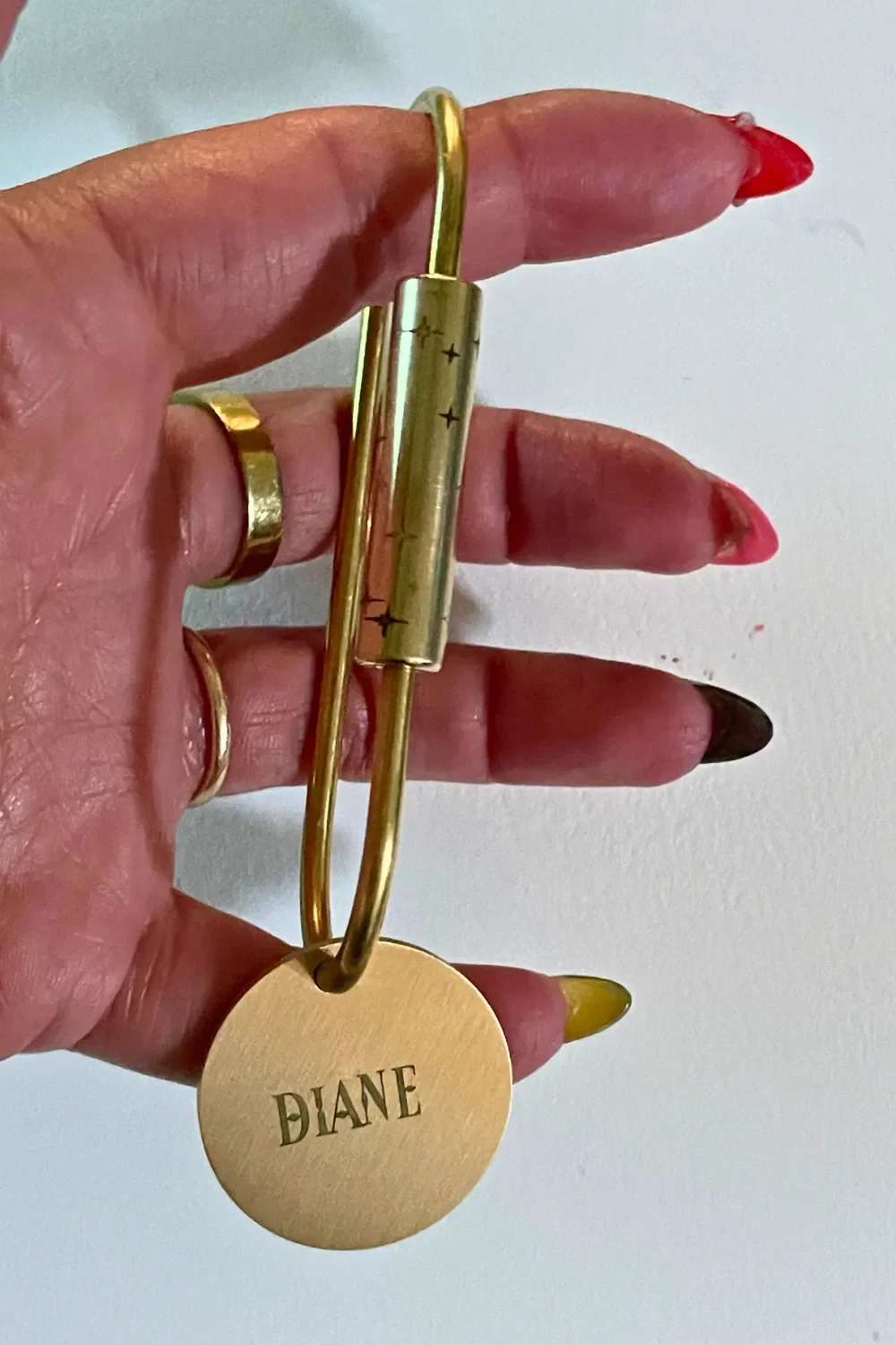 North Star design engraved on brass locking keychain with custom brass name tag