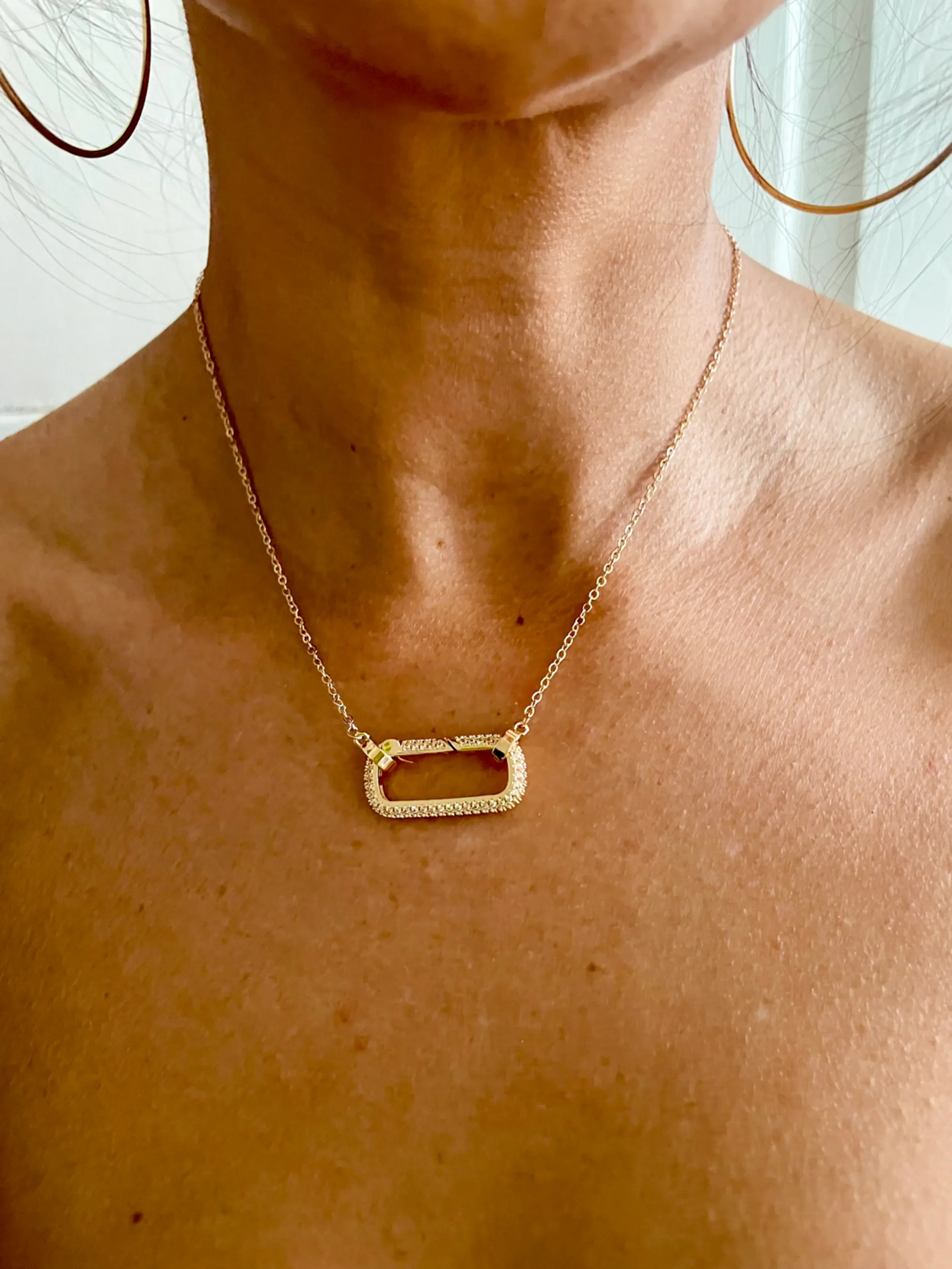 women wearing gold pave carabiner necklace