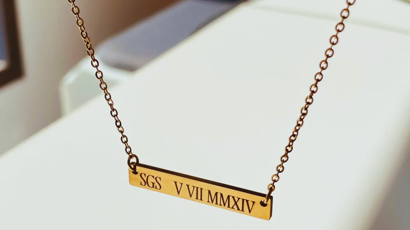 Initials and Roman Numerals Date engraved on gold bar necklace