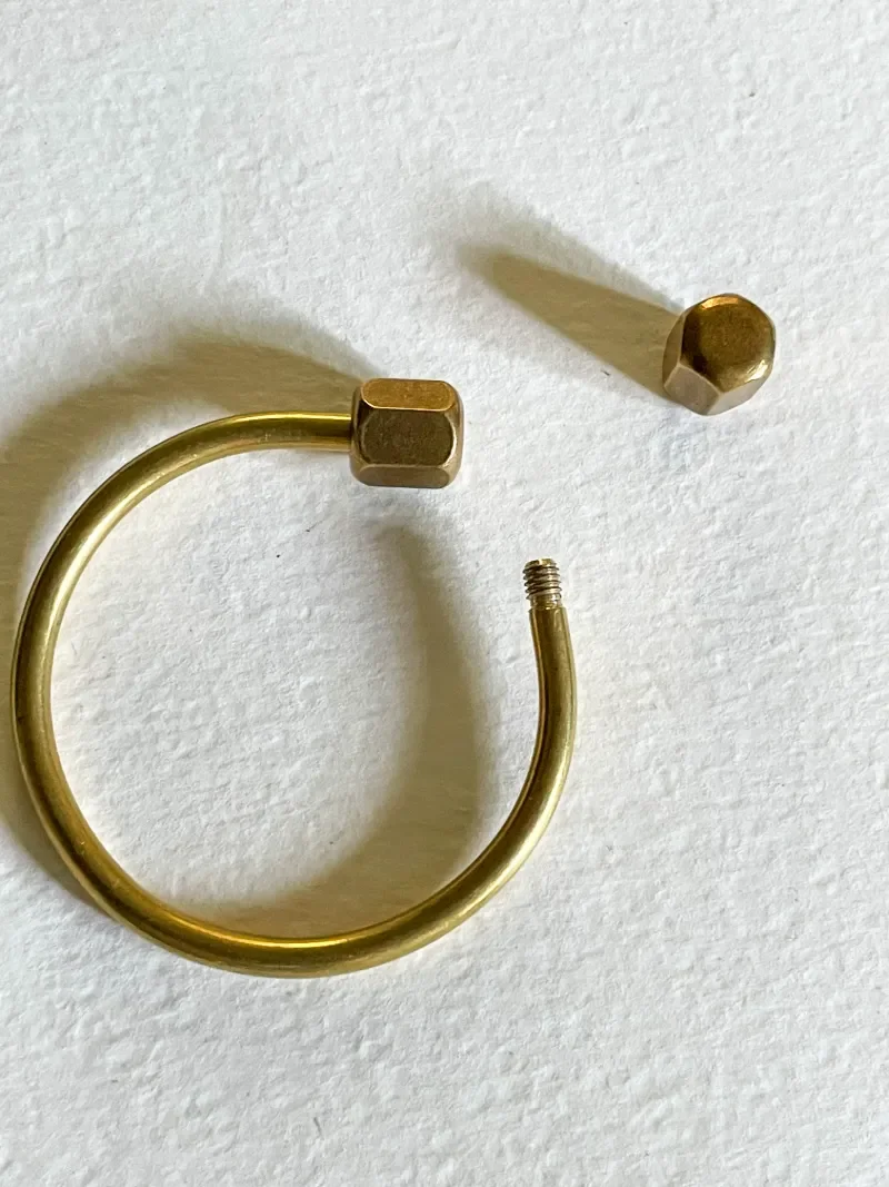 Unscrewed brass horseshoe key ring to load keys
