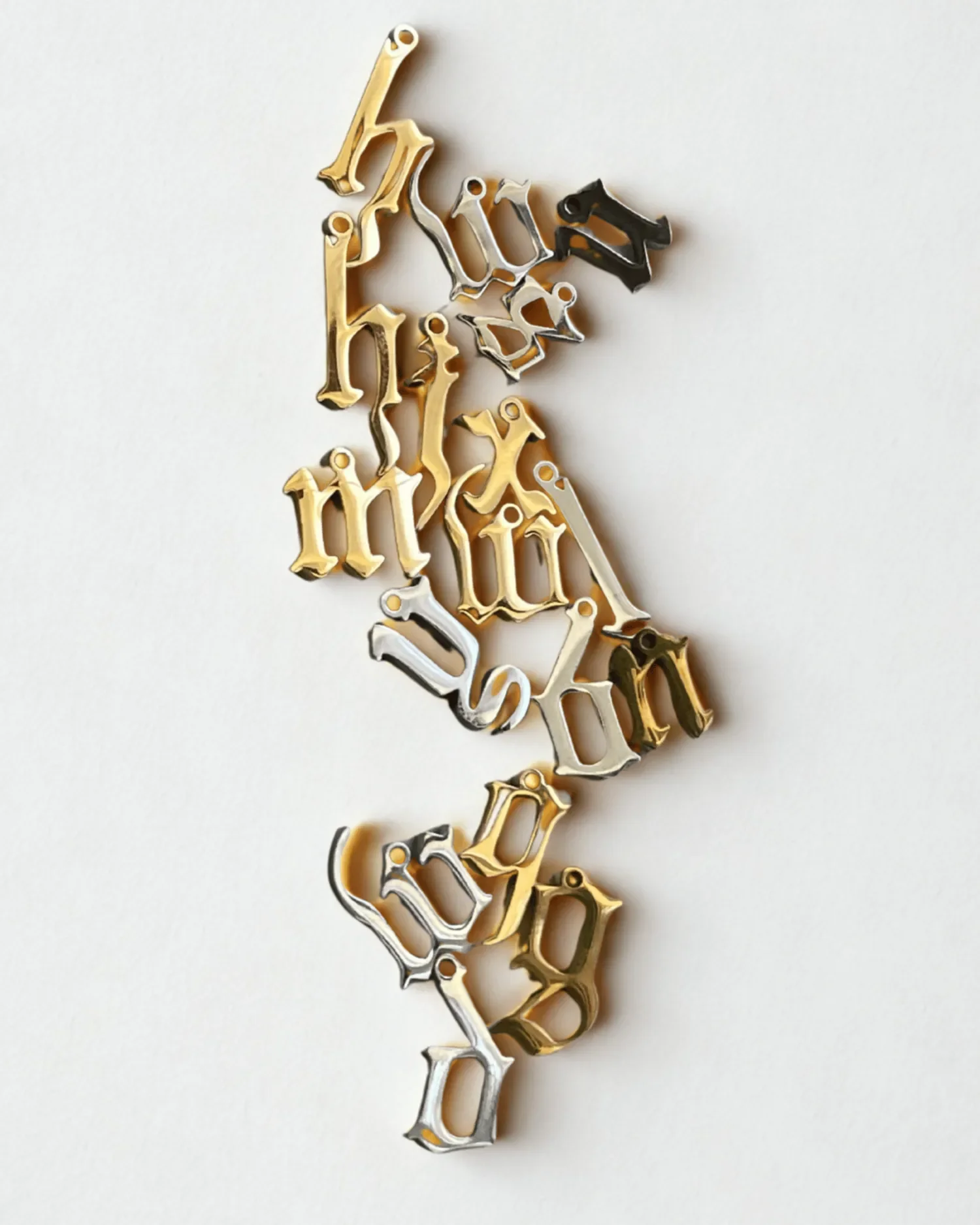 Gold and silver gothic letter charms