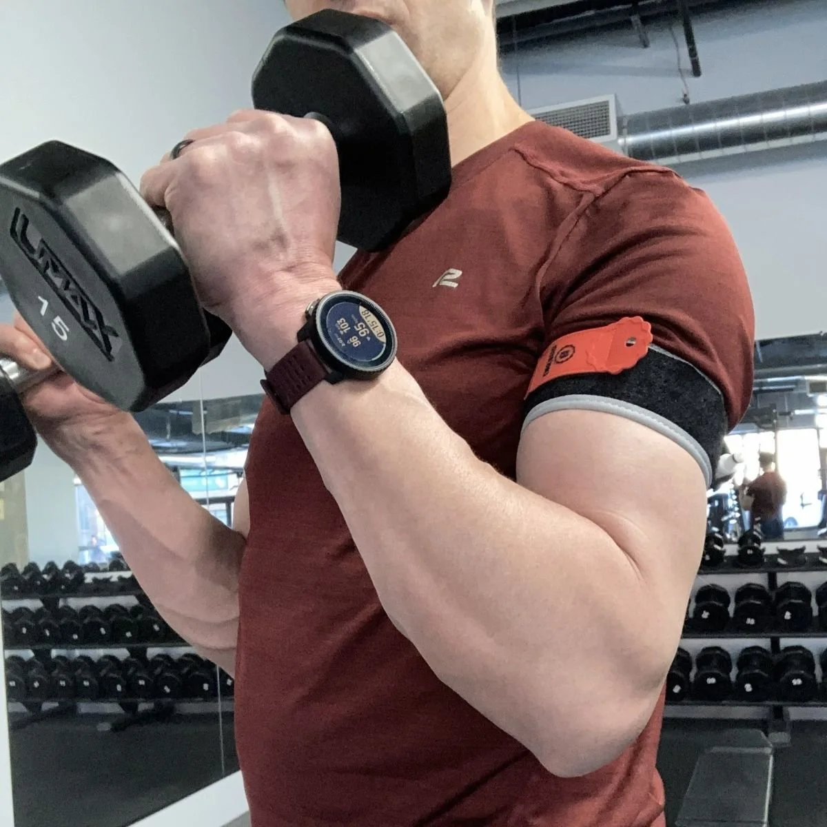 Blood flow restriction training during physical therapy with bicep curls using dumbbells