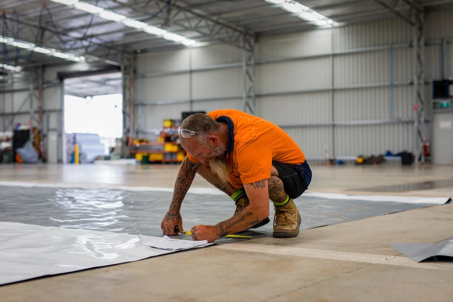 man-measuring-the-tarpaulin.jpg