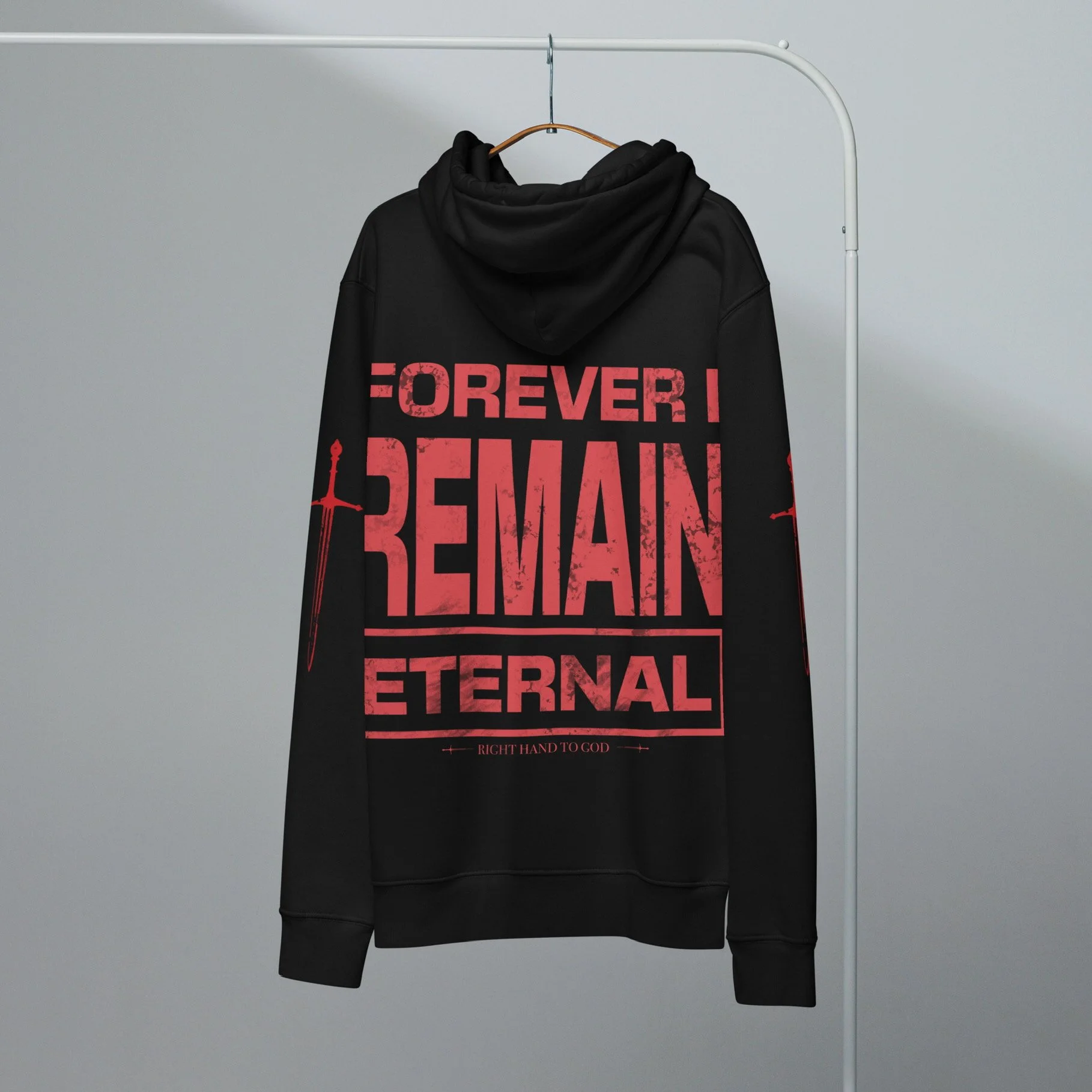 Black hoodie with red text that reads "FOREVER! REMAIN ETERNAL" hanging on a wooden hanger on a white clothing rack against a plain gray background.