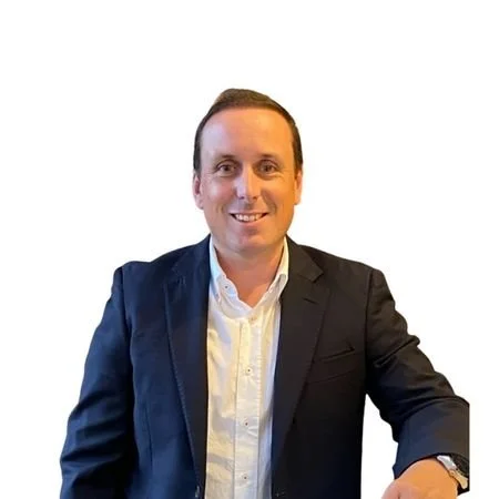 A man in a blue suit and white shirt.