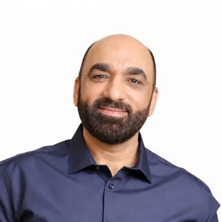 A man in a blue suit and white shirt.