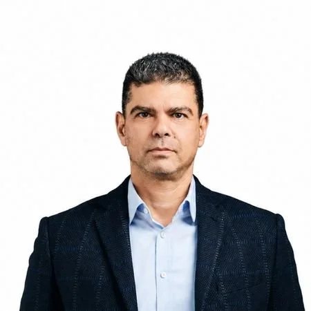 A man wearing a white shirt, and watch on the wrist.