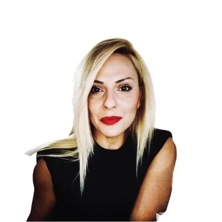 A woman with blonde hair and a black blouse.