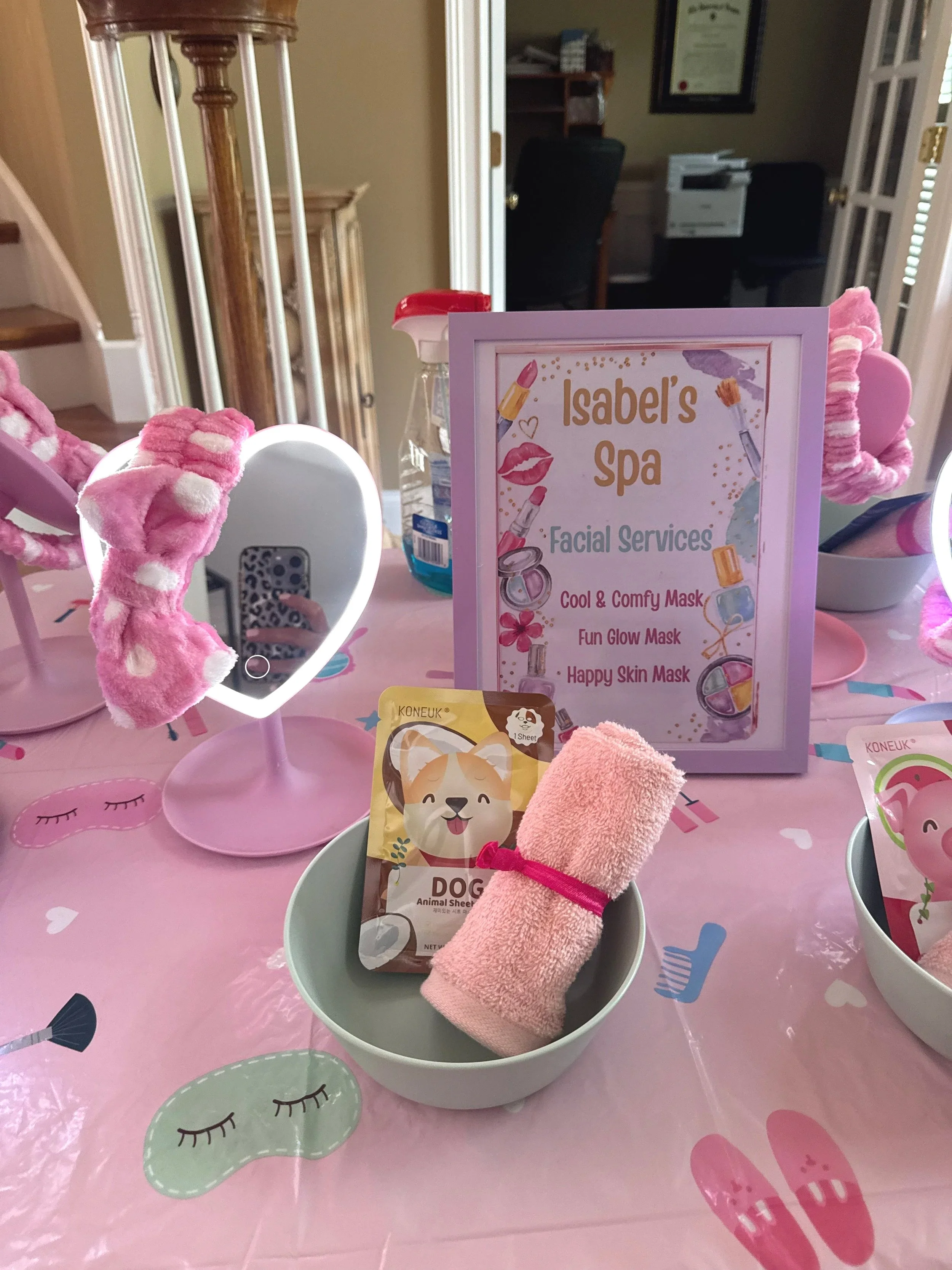 Girly Spa Tablescape with bows, mirrors, signage, washcloths, headbands, and masks