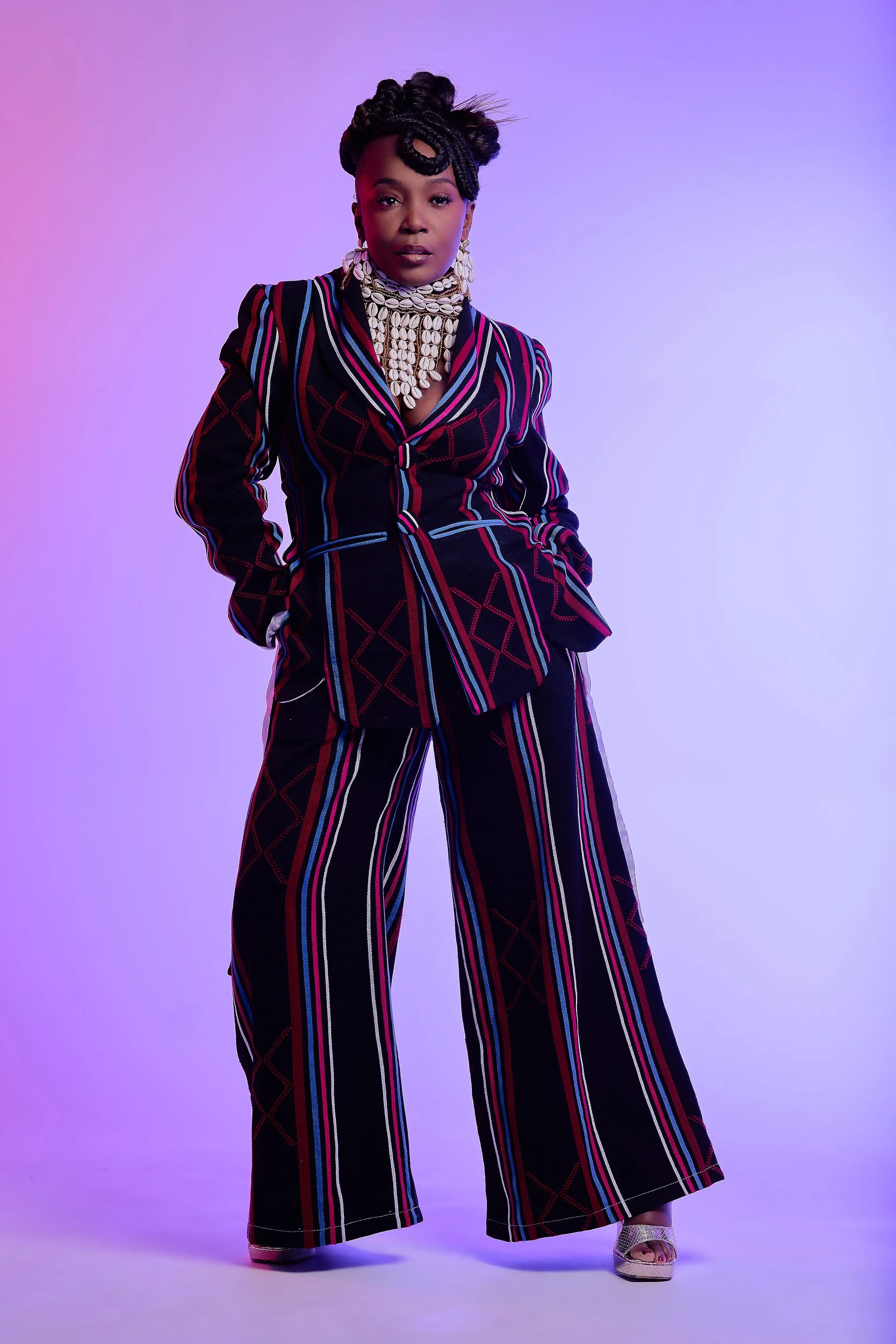  NYNY RYKE founder Fallylah Nyny Ryke Goungou with handwoven textiles NYNY RYKE sustainable luxury collection Togo Italy craftsmanship AIDA Award winner NYNY RYKE sustainable fashion brand Nyasha Michelle wearing NYNY RYKE Issue 10 cover feature 