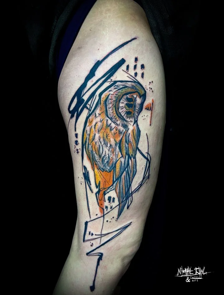 Abstract owl with three eyes tattoo on the thigh, brushstroke and some color