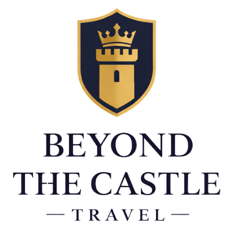 Logo of Beyond the Castle Travel featuring a black shield with a gold crown and castle tower, and the company name below.