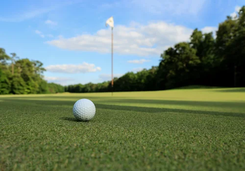 Golf ball on grass representing Masters Tournament travel packages