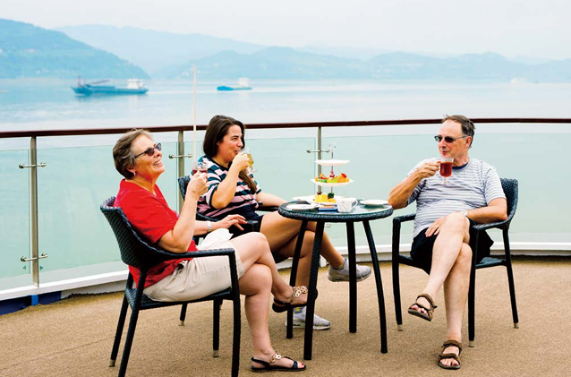 Travelers relaxing with drinks on the open deck during a Yangtze River cruise