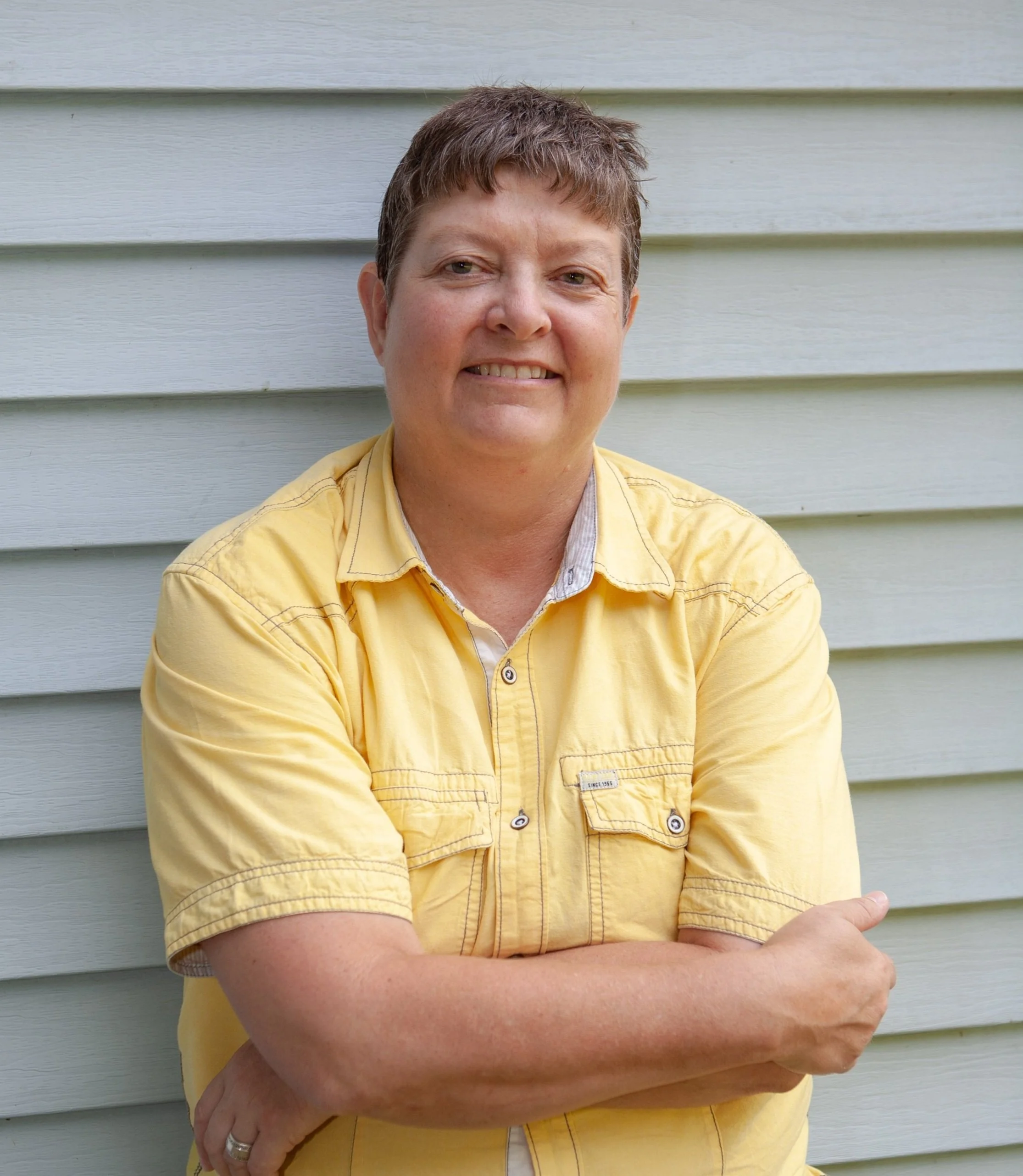 Front cover of a book with the image of women in yellow shirt holding a dog