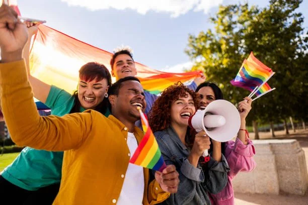 Close-up of rainbow-colored rainbow flag fabric, with rainbow stripes and bright colors, shading and folds.