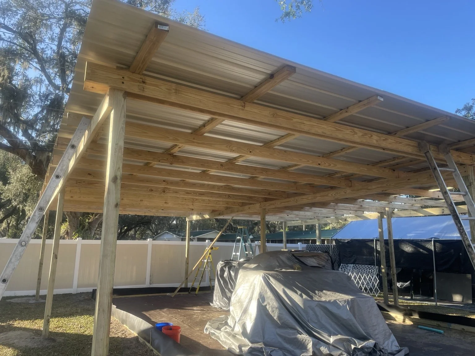 Custom lean-to pole barn designed and built by Abundance of Sunshine Inc. in Lakeland, Florida, providing durable covered space for outdoor storage and equipment.