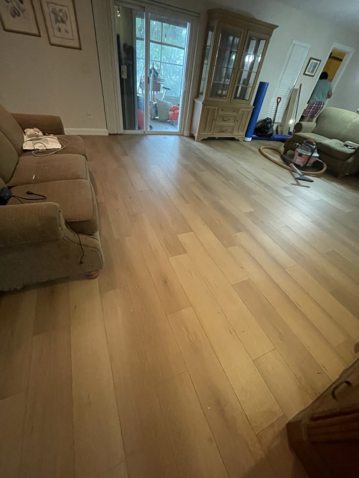 Completed wood-flooring replacement at a Tampa home by Abundance of Sunshine Inc. We moved the furniture, removed the old flooring, leveled and prepared the subfloor, and installed the new wood flooring.