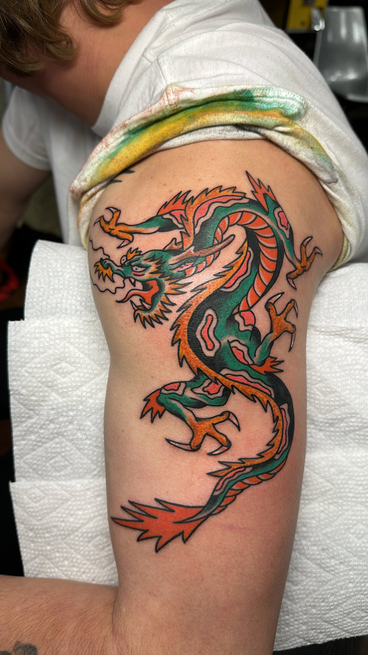 Colorful dragon tattoo on upper arm