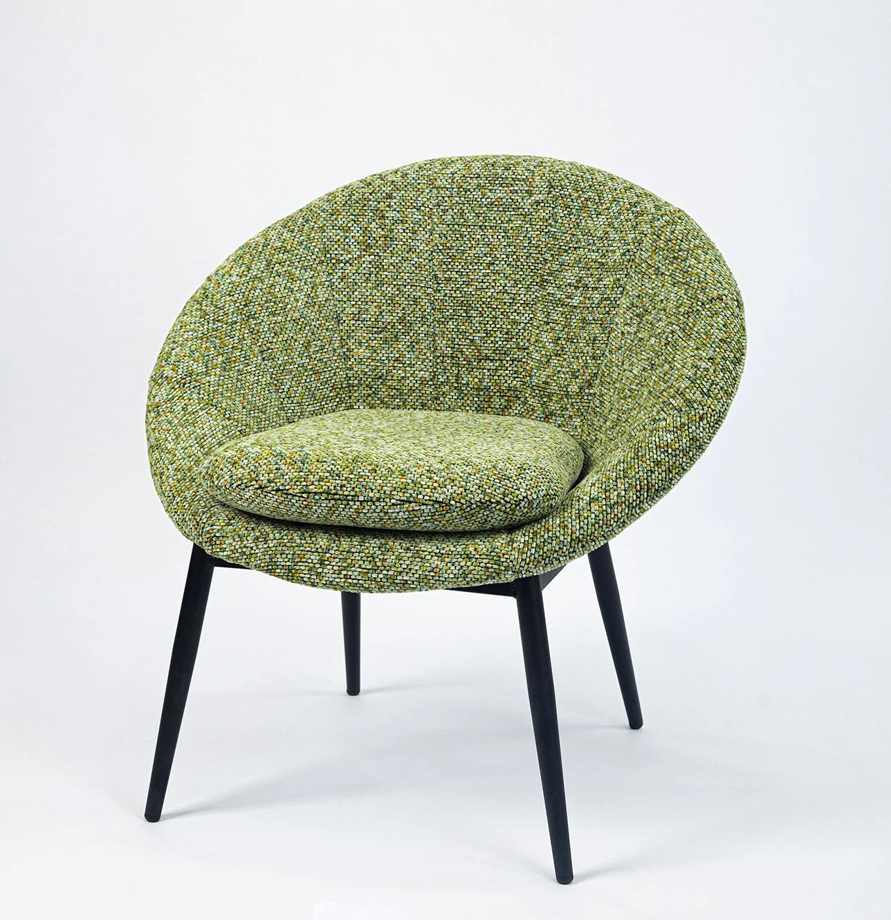 Green patterned modern armchair with black legs against a white background.