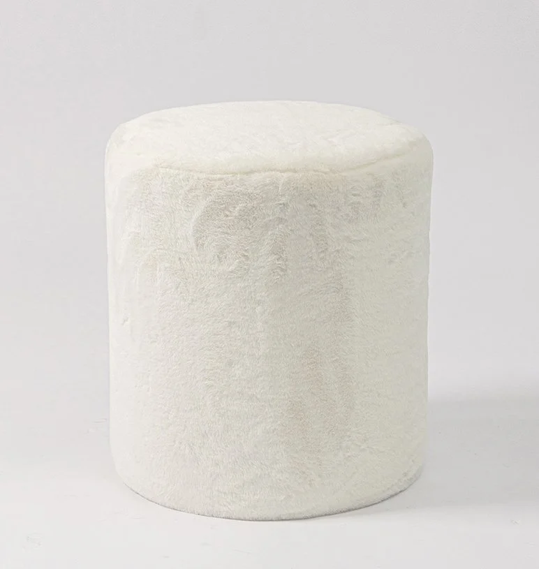 A white, cylindrical marshmallow on a plain background.