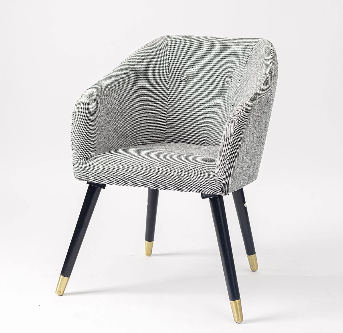 A modern gray upholstered armchair with black wooden legs and gold accents on the feet, set against a plain white background.