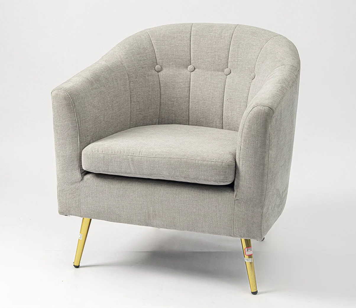 A light gray upholstered armchair with vertical tufting and wooden legs against a plain white background.