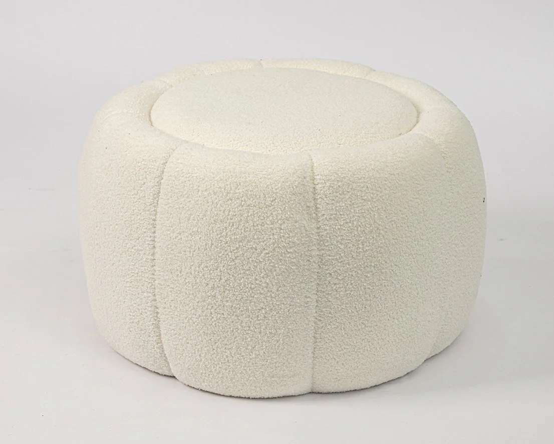 A round, white, textured ottoman or stool with a hollow center.