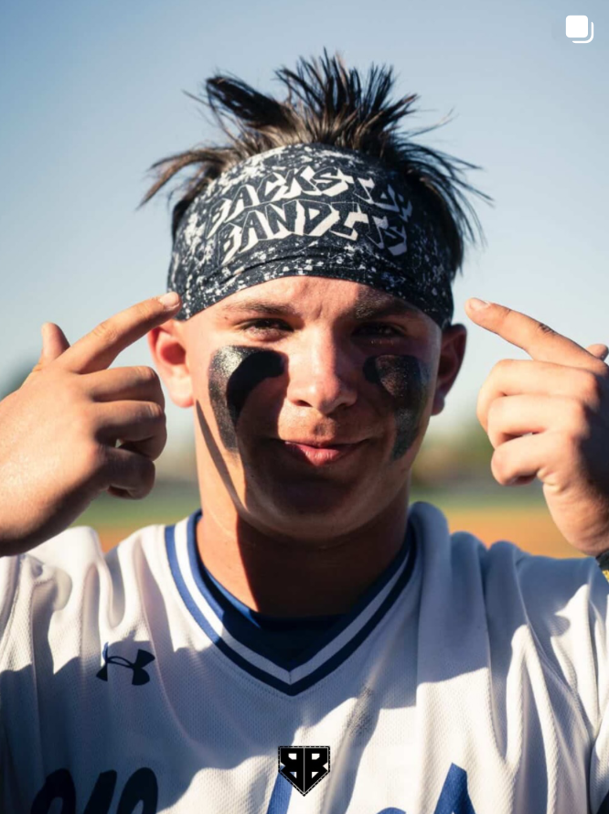 UNC Bears Baseball catcher Yale Johnson pointing to his JUNK Brands x Backstop Bandits headband