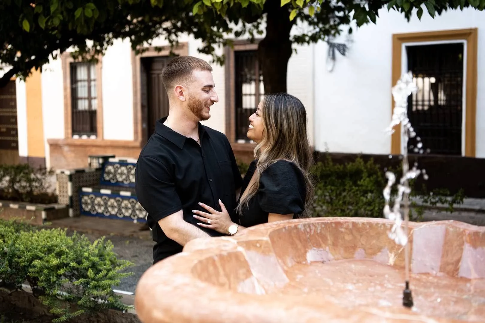 A couple smiling at each other in Seville’s Santa Cruz