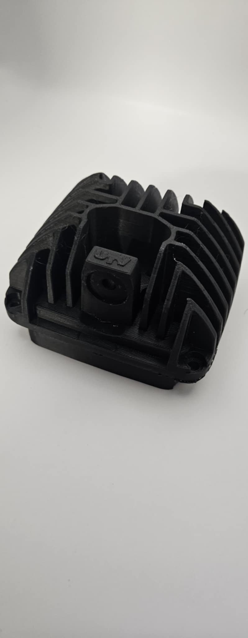 Black metal heatsink component on a white background