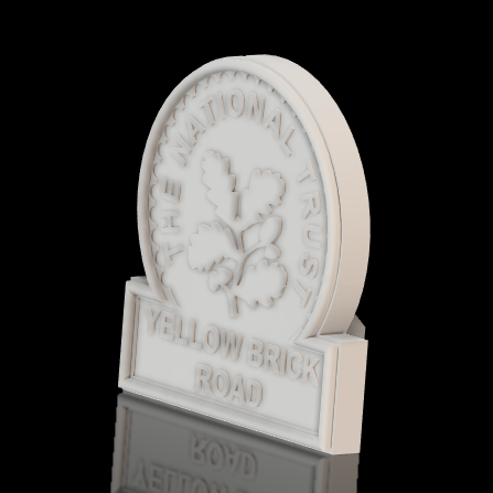 White 3D printed sign with the words "The National Trust" and "Yellow Brick Road" engraved, featuring a clover leaf design, set against a black background.