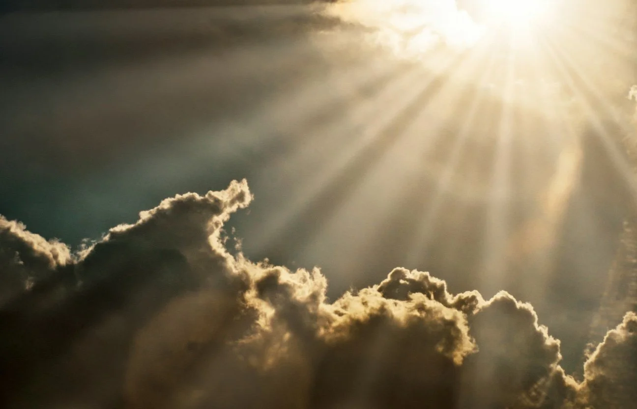 Soft sunlight breaking through clouds in the sky, symbolizing hope, emotional healing, and support through therapy and counseling.