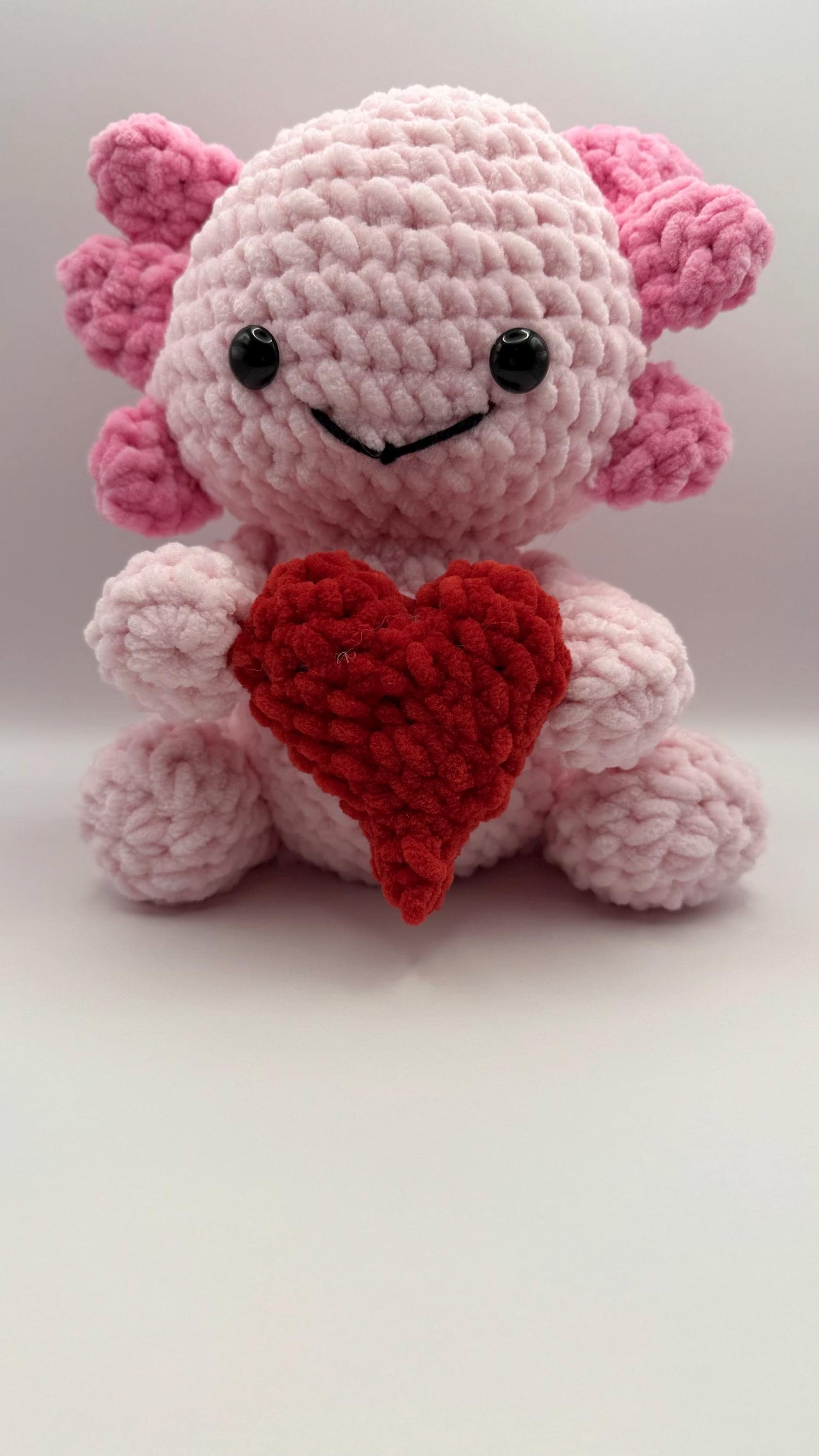 Soft and cuddly handmade crochet axolotl plush, a perfect gift for amphibian lovers.