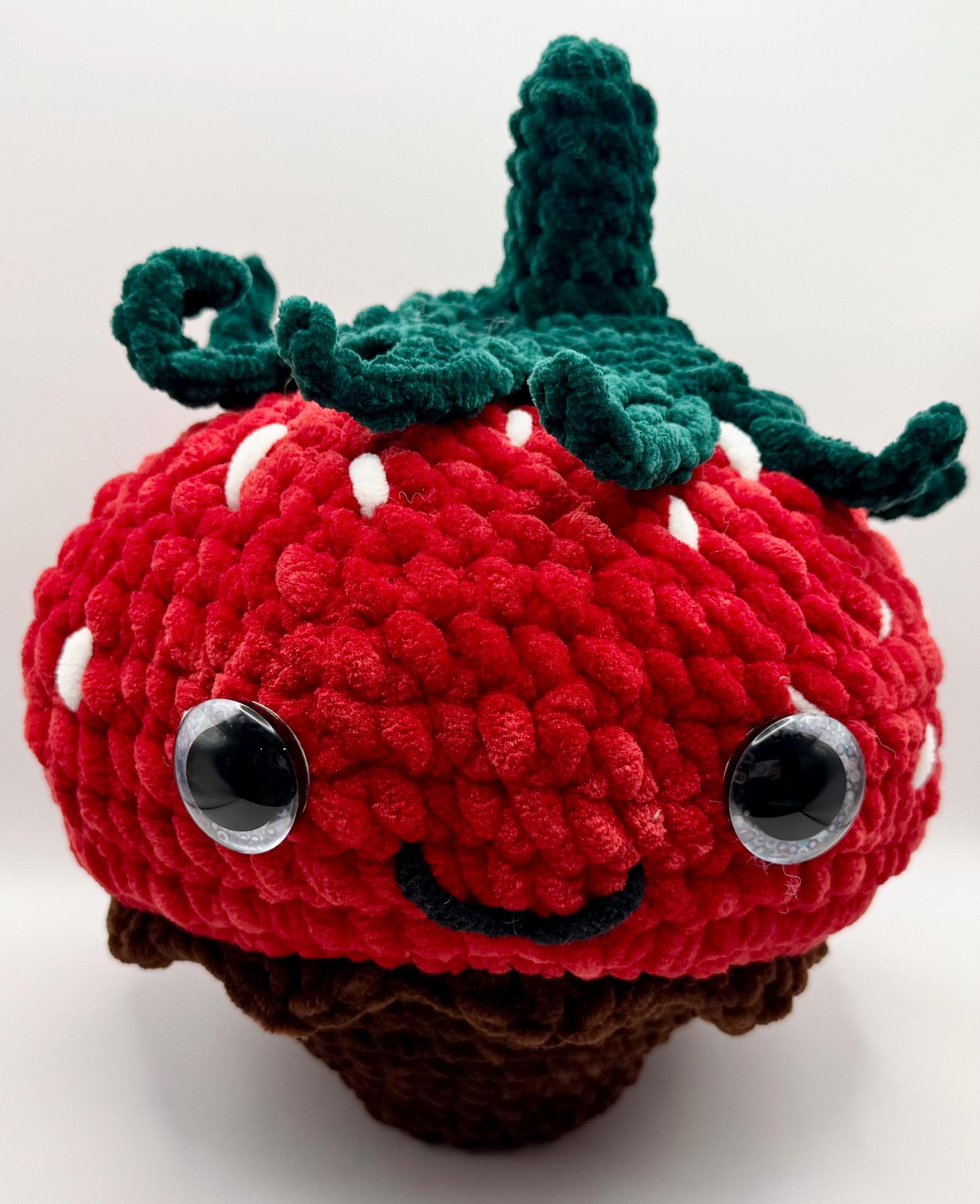 Realistic handmade crochet chocolate-covered strawberry plush, a sweet and unique decor piece.