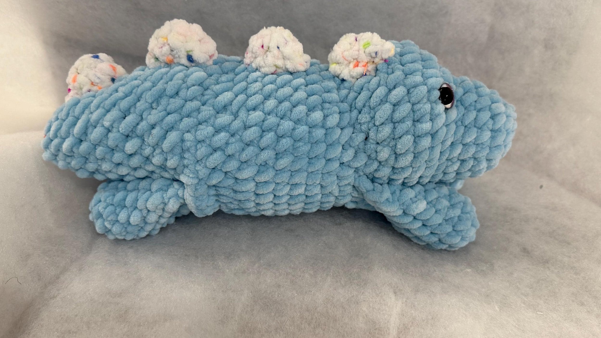 Cute handmade crochet dinosaur plushie, perfect for dino lovers and kids.