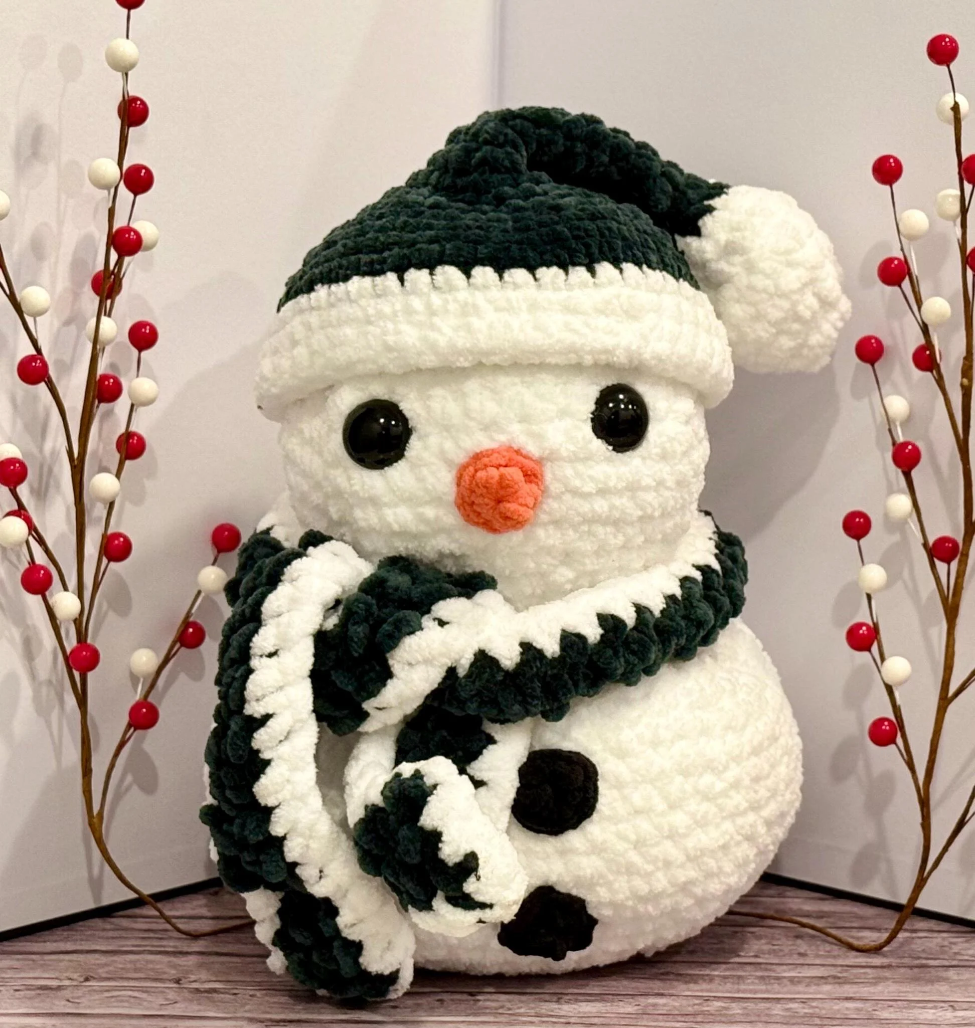 Handmade crochet snowman plushie with a cozy winter charm, perfect for holiday decor.